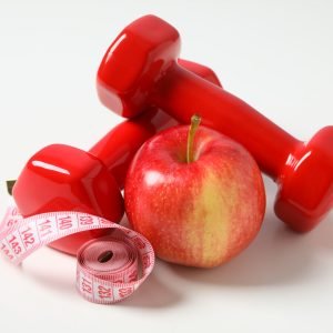 Concept of weight loss and healthy nutrition with apple and meas Concept of weight loss and healthy nutrition with apple and measuring tape
